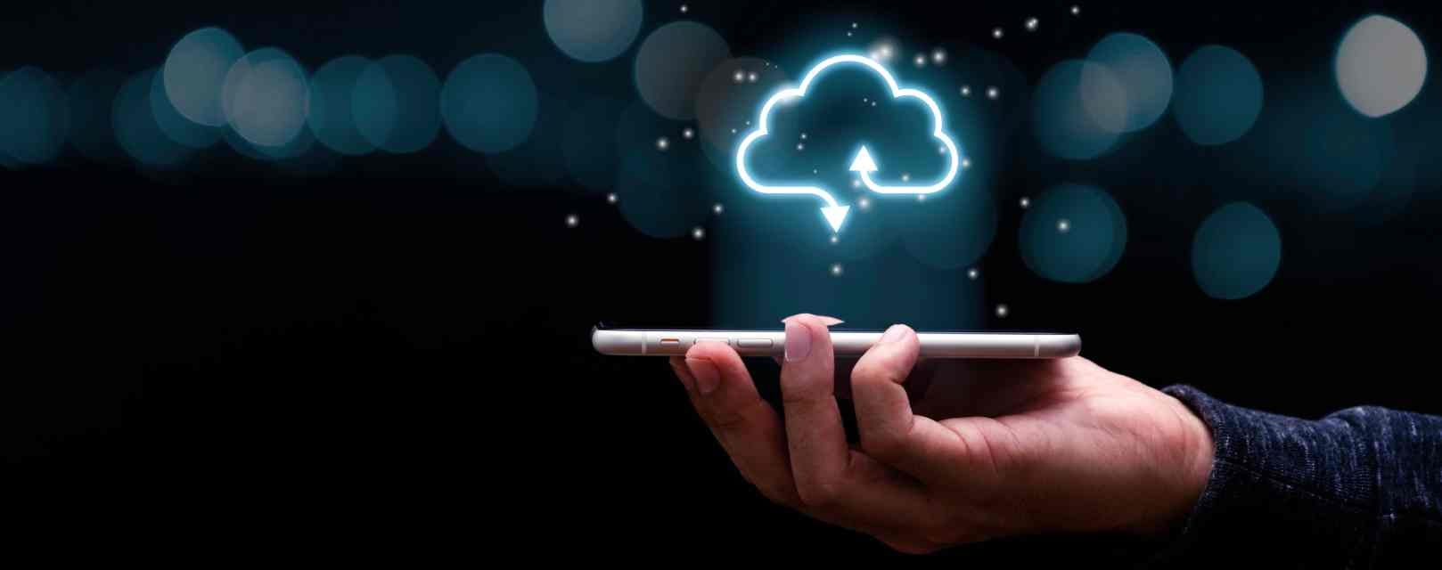 secure digital transformation. Businessman holding mobile phone with virtual cloud computing to transfer data information and upload download application. Technology transformation concept.