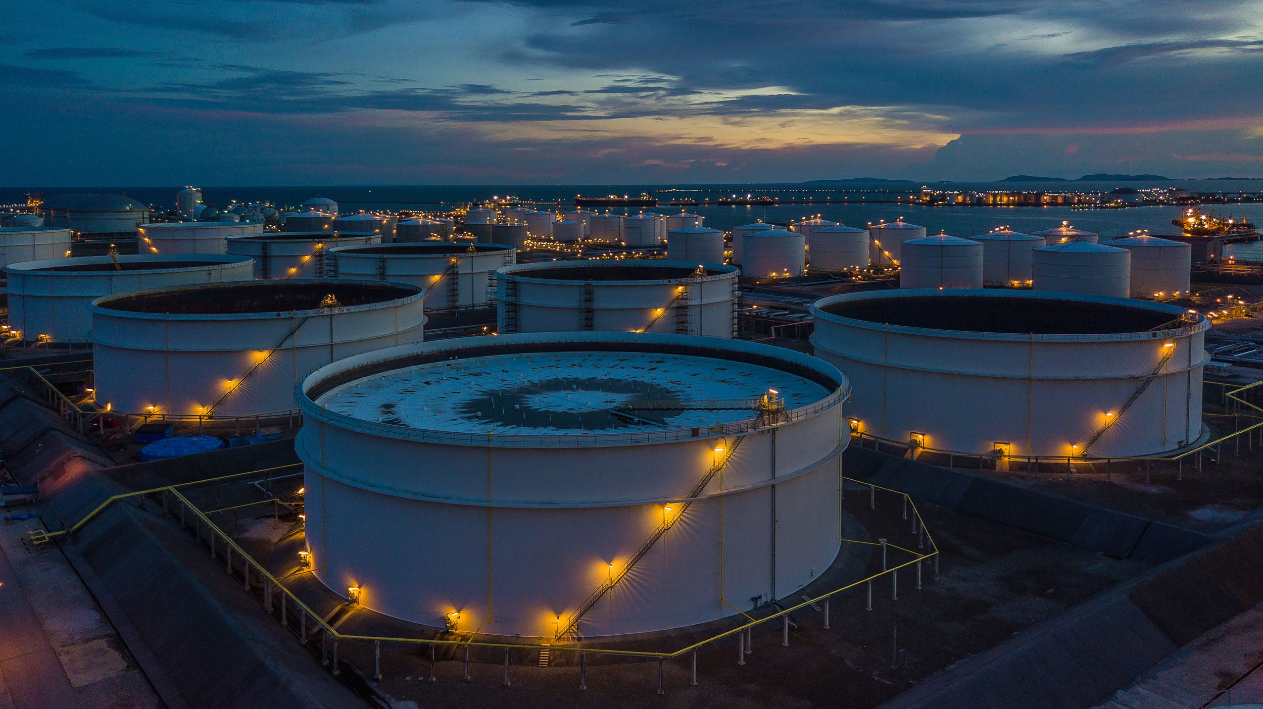 Aerial view oil terminal is industrial facility for storage of oil and petrochemical products ready for transport to further storage facilities.