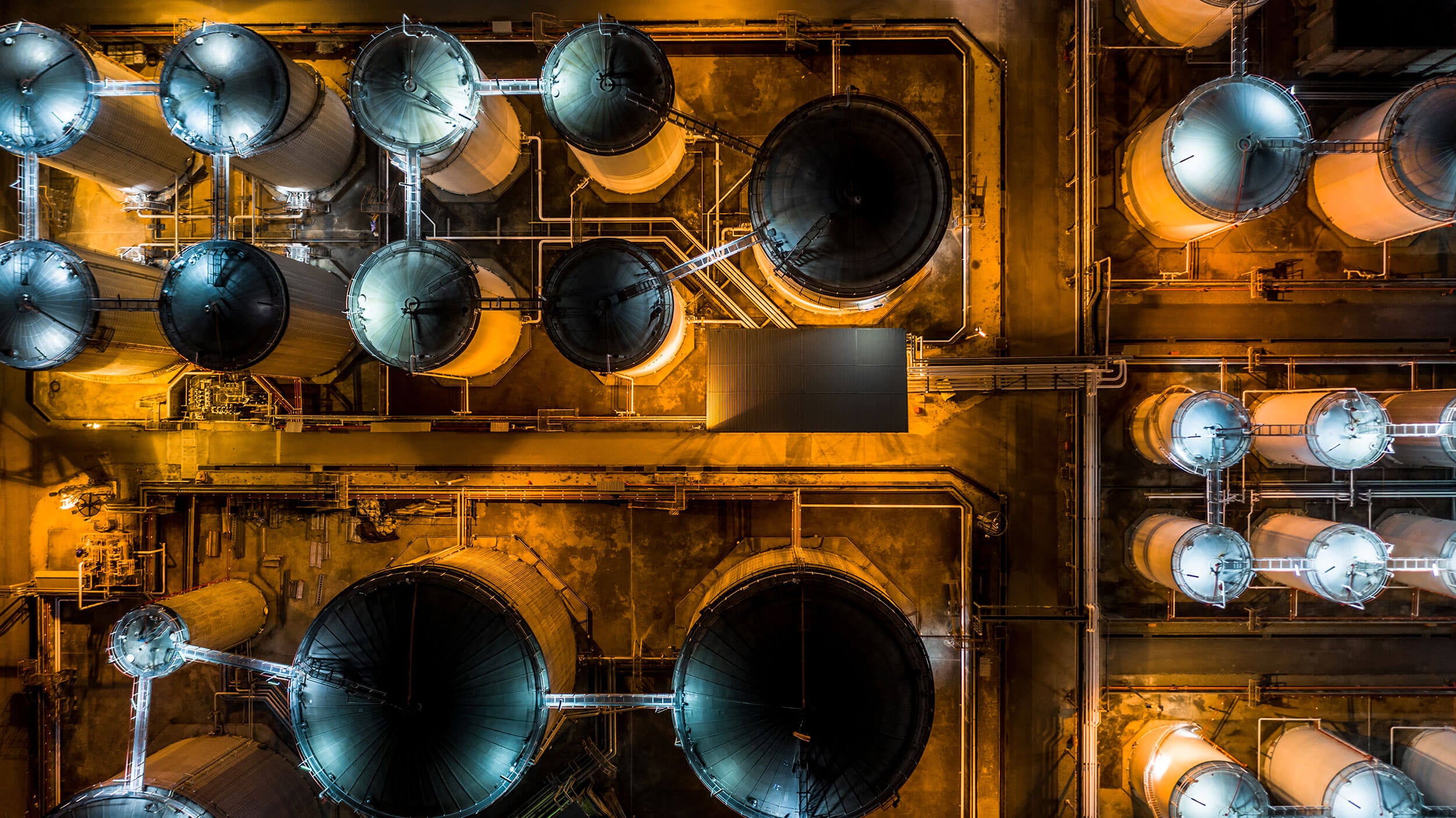 Liquid chemical tank terminal, Storage of liquid chemical and petrochemical products tank, Aerial view at night.