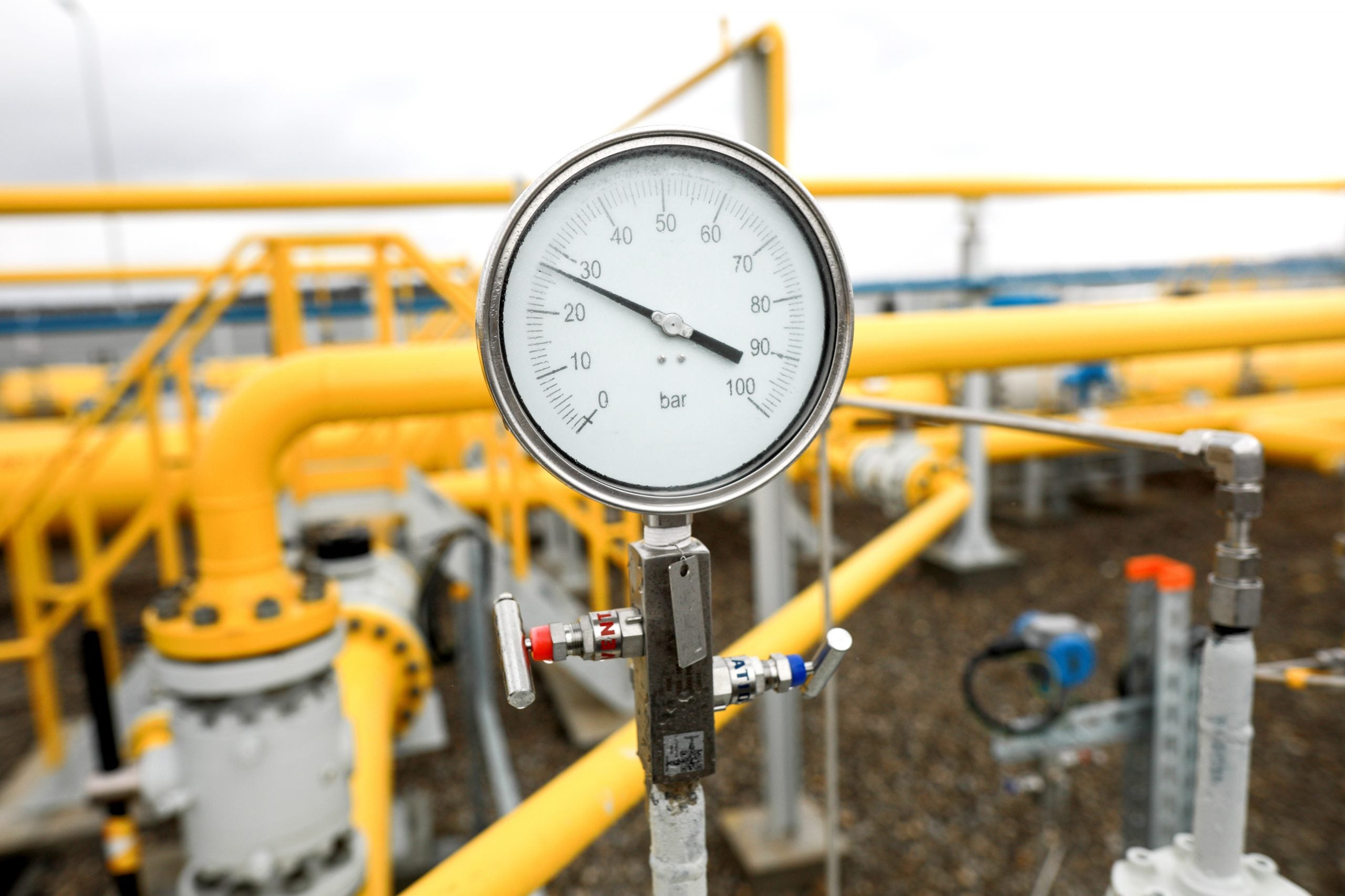 Industrial equipment (pipes, manometer/pressure gauge, levers, faucets, indicators) in a natural gas compressor station.