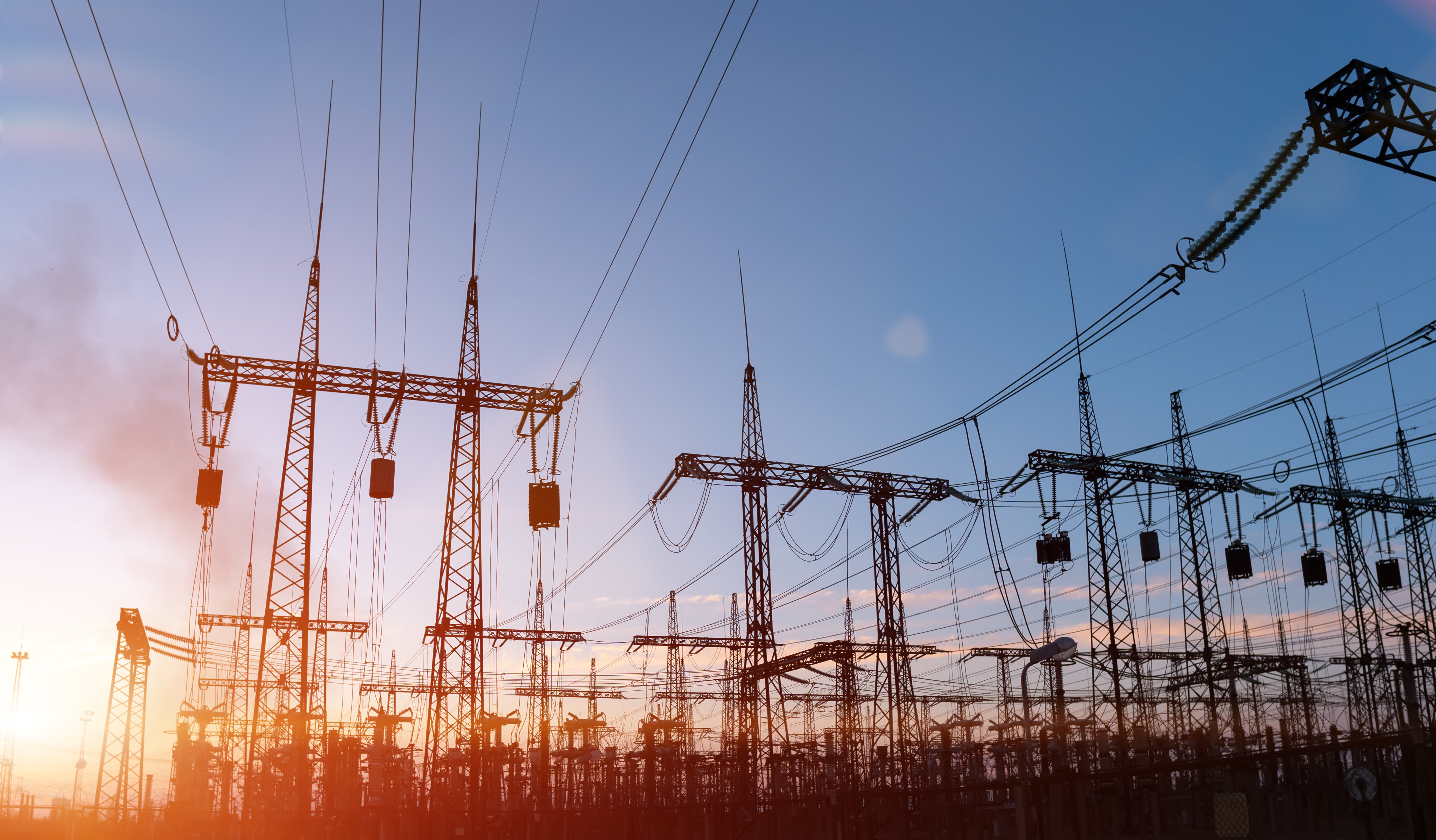 High-voltage power lines. Electricity distribution station. high voltage electric transmission tower. Distribution electric substation with power lines and transformers.
